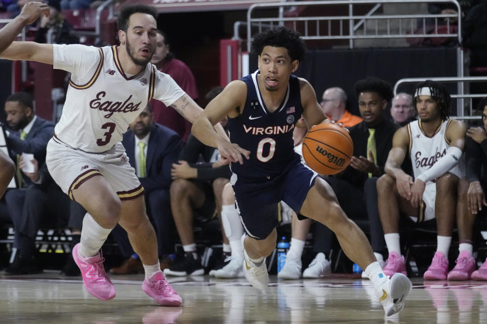 Virginia guard Kihei Clark (0) drives to the basket against Boston College guard Jaeden Zackery (3) during the first half of an NCAA college basketball game, Wednesday, Feb. 22, 2023, in Boston. (AP Photo/Charles Krupa)