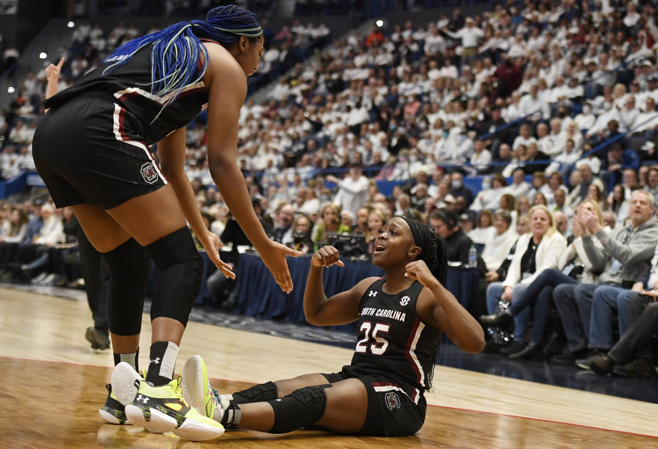 South Carolina's Raven Johnson (25) reacts toward teammate Aliyah Boston, left, in the first half of an NCAA college basketball game, Sunday, Feb. 5, 2023, in Hartford, Conn. (AP Photo/Jessica Hill)