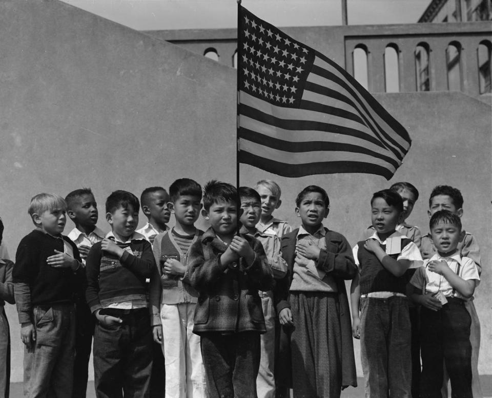 San Francisco, California. Flag of allegiance pledge at Raphael Weill Public School, Geary and Buchanan Streets. Children in families of Japanese ancestry were evacuated with their parents and will be housed for the duration in War Relocation Authority centers where facilities will be provided for t hem to continue their education, 1942 (Courtesy National Archives, photo no. 210-G-C122)