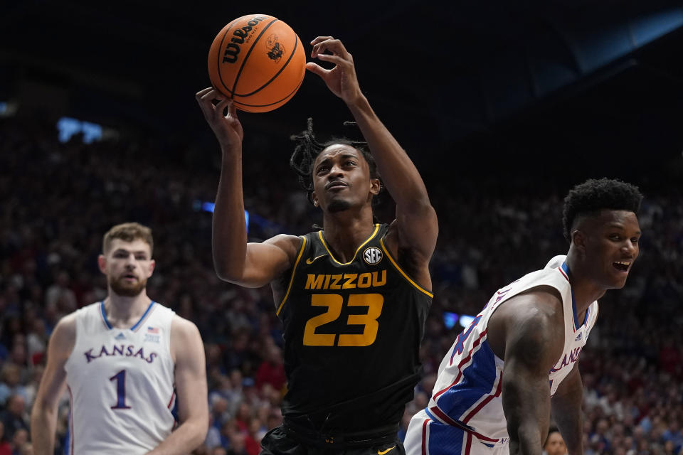Missouri forward Aidan Shaw (23) grabs a rebound during the first half of an NCAA college basketball game against Kansas Saturday, Dec. 9, 2023, in Lawrence, Kan. (AP Photo/Charlie Riedel)