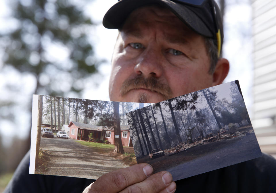 In this Thursday Oct. 24, 2019, photo, Bill Husa displays before-and-after photos of his home lost in last year's Camp Fire in Paradise, Calif. Husa's home is one of nearly 9,000 Paradise homes destroyed in the deadliest and most destructive wildfire in California history. (AP Photo/Rich Pedroncelli)