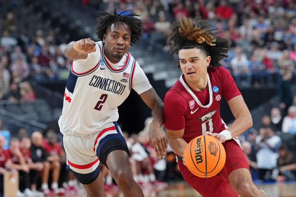 Arkansas Razorbacks guard Anthony Black dribbles the ball against UConn Huskies guard Tristen Newton during the first half at T-Mobile Arena, March 23, 2023 in Las Vegas.