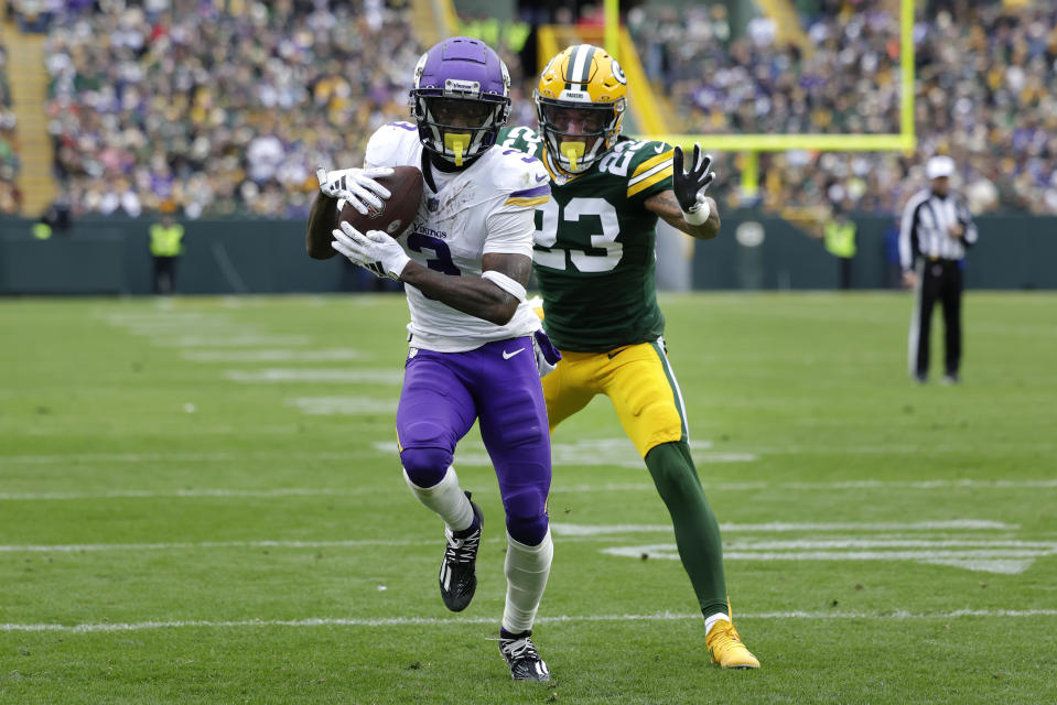 Minnesota Vikings wide receiver Jordan Addison (3) catches a pass against Green Bay Packers cornerback Jaire Alexander (23) to score a 20-yard touchdown during the second half of an NFL football game Sunday, Oct. 29, 2023, in Green Bay, Wis. (AP Photo/Matt Ludtke)