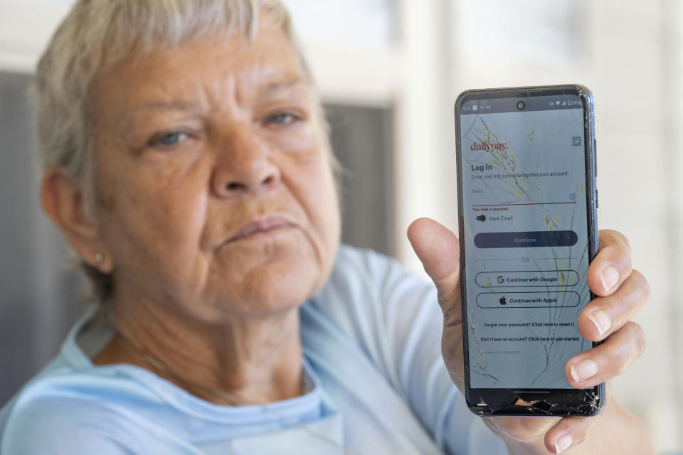 Sheri Wilkins talks about her experience using the DailyPay app outside of the clubhouse at her apartment complex in College Station, Texas on Tuesday, March 26, 2024. (AP Photo/Sam Craft)