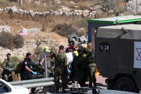 Body is carried at the scene of what Israeli military said is a car-ramming attack near the https://www.reutersconnect.com/detail?id=tag%3Areuters.com%2C2019%3Anewsml_LYNXNPEF7F116%3A1settlement of Elazar in the Israeli-occupied West Bank