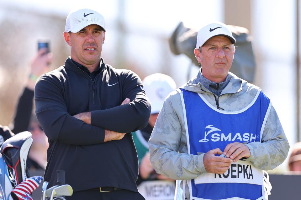 Brooks Koepka of Smash GC talks with his caddie Ricky Elliott on the 16th hole during day three of the LIV Golf Invitational - Las Vegas at Las Vegas Country Club on February 10, 2024 in Las Vegas, Nevada. (Photo by Michael Reaves/Getty Images)