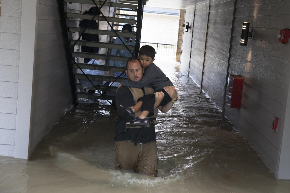 Volunteer Dustin Langley, who lives two hours north of Houston and came down with a friend to volunteer, helps a family to escape their flooded apartment in Kingwood.&nbsp;