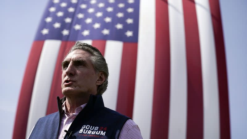 Republican presidential candidate North Dakota Gov. Doug Burgum speaks during an interview following a town hall meeting with employees at Rueter’s Equipment, Friday, June 9, 2023, in Elkhart, Iowa. Burgum was transported to an emergency room in Milwaukee after suffering a basketball injury, and it is unclear whether he will be in attendance at the first GOP primary debate on Wednesday, Aug. 23.