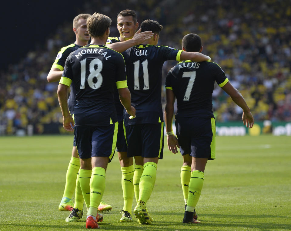 Football Soccer Britain - Watford v Arsenal - Premier League - Vicarage Road - 27/8/16 Arsenal's Mesut Ozil celebrates scoring their third goal with team mates Reuters / Hannah McKay Livepic EDITORIAL USE ONLY. No use with unauthorized audio, video, data, fixture lists, club/league logos or "live" services. Online in-match use limited to 45 images, no video emulation. No use in betting, games or single club/league/player publications. Please contact your account representative for further details.