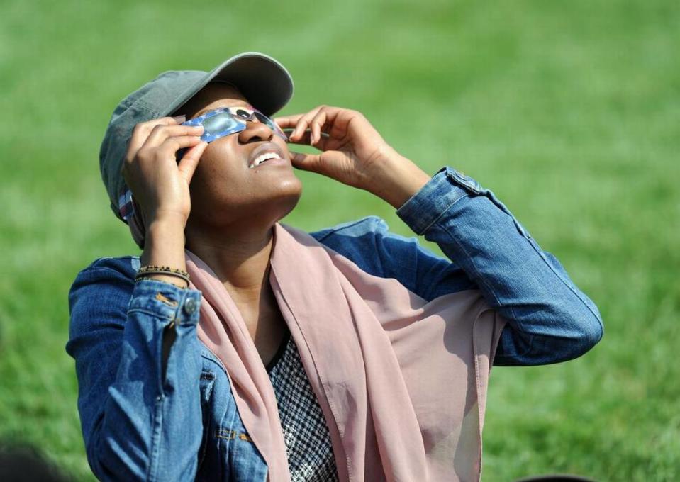 Fanta Conde looks at the eclipse Monday, Aug. 21, 2017 at The Arboretum at Penn State.