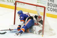 New York Islanders' Kyle Palmieri (21) crashes into New Jersey Devils goaltender Mackenzie Blackwood (29) while scoring a goal during the third period of an NHL hockey game Saturday, May 8, 2021, in Uniondale, N.Y. The Islanders won 5-1. (AP Photo/Frank Franklin II)