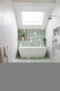 <p> There are several things to love about this bathroom. Firstly, the light! And secondly, we love how the Brasilia floor tiles from Popham Design have continued up the wall, which draws your eye away from the fact that the bathroom is actually super narrow. </p> <p> The beautiful white Victoria + Albert Eldon bath breaks up the pattern, yet the shape of it and the white pattern on the tiles link cleverly. The gold taps, shower, and towel rail add a hint of warmth to the white-painted side walls finishing off the space to a T.  </p>