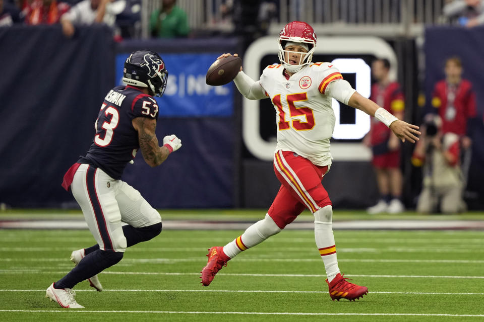 Kansas City Chiefs quarterback Patrick Mahomes (15) is pressured by Houston Texans linebacker Blake Cashman (53) as he looks to throw during the first half of an NFL football game Sunday, Dec. 18, 2022, in Houston. (AP Photo/David J. Phillip)