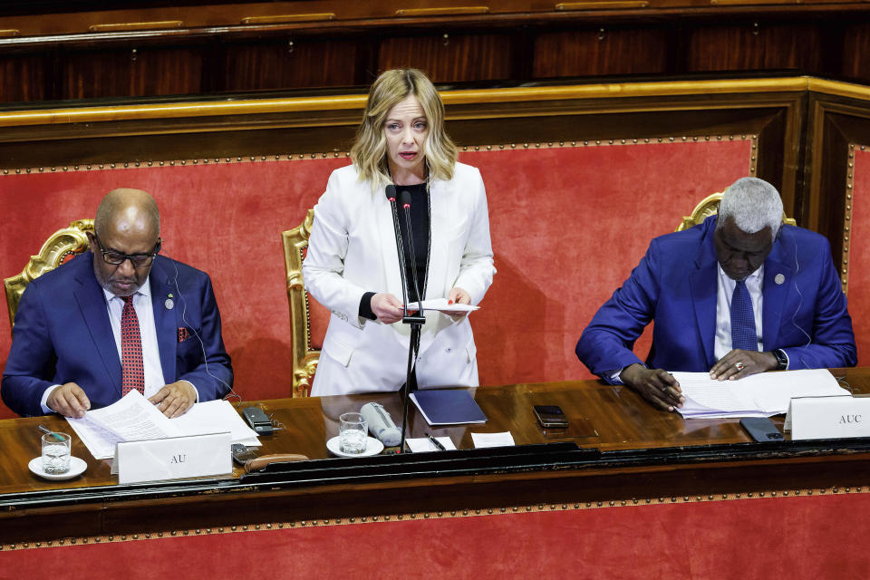 Italian Premier Giorgia Meloni, center, speaks as she is flanked by African Union President Azali Assoumani, left, and African Union Commission Chairperson Moussa Faki Mahamat, at the Senate for the start of an Italy - Africa summit, in Rome, Monday, Jan. 29, 2024. Meloni opened a summit of African leaders on Monday aimed at illustrating Italy's big development plan for the continent that her government hopes will stem migration flows and forge a new relationship between Europe and Africa. (Roberto Monaldo/LaPresse via AP)