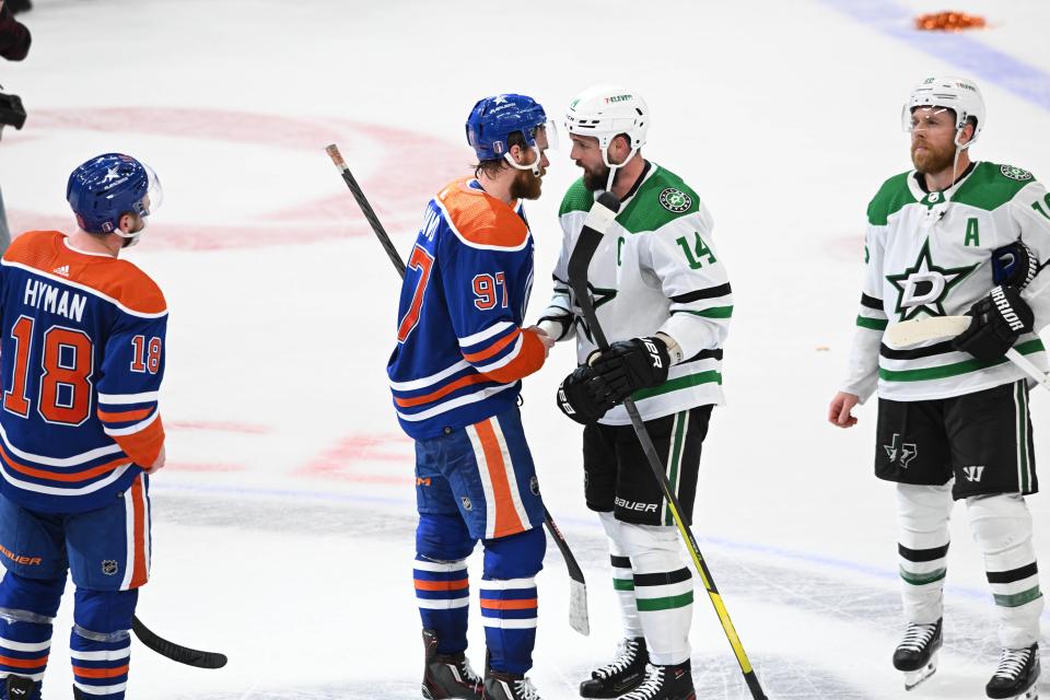 Jun 2, 2024; Edmonton, Alberta, CAN; Oilers centre Connor McDavid (97) shakes hands with Dallas Stars left winger Jamie Benn (14) at the end of the third period in game six of the Western Conference Final of the 2024 Stanley Cup Playoffs at Rogers Place. Mandatory Credit: Walter Tychnowicz-USA TODAY Sports