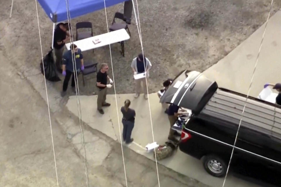 In this image taken from video provided by KTLA, law enforcement personnel work at the scene following an explosion during an indoor training exercise, Wednesday, March 13, 2024, in Irvine, Calif. An explosion during an indoor training exercise Wednesday sent 16 members of Southern California's Orange County Sheriff’s Department SWAT team to the hospital, with one person requiring surgery for a leg injury, the department said. (KTLA via AP)