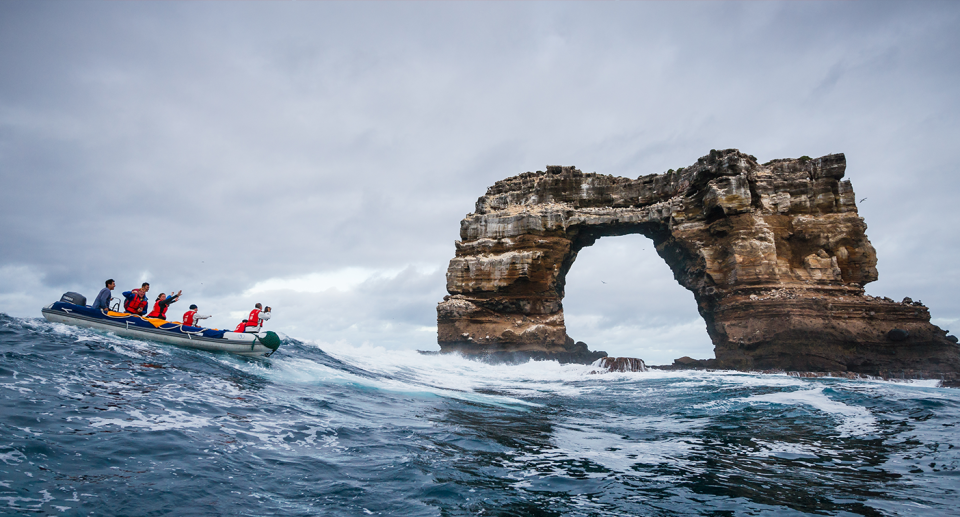 Darwin's Arch pictured before its collapse with tourists visiting nearby.