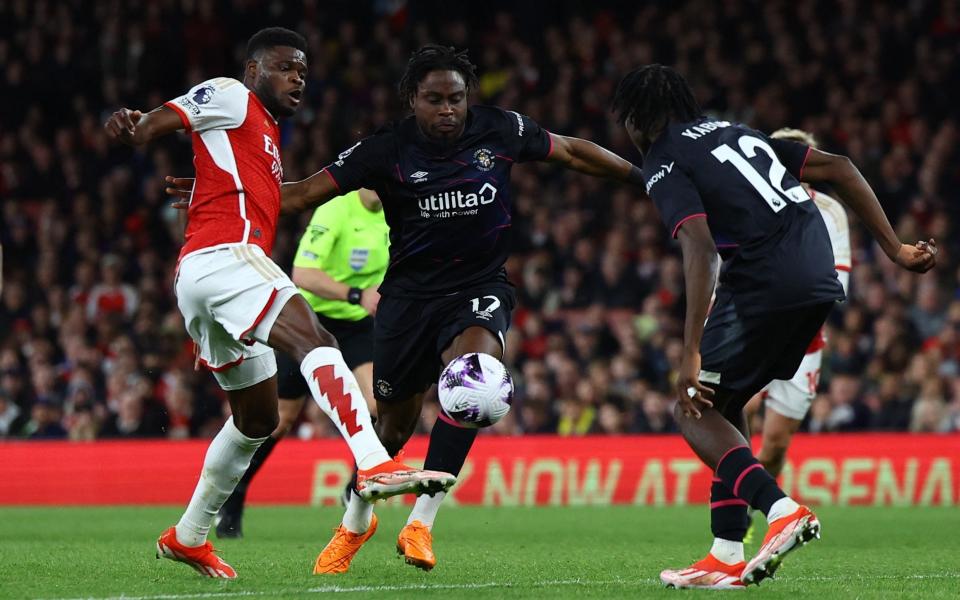 Arsenal v Luton Town - Emirates Stadium, London, Britain - April 3, 2024 Arsenal's Thomas Partey in action with Luton Town's Pelly Ruddock Mpanzu