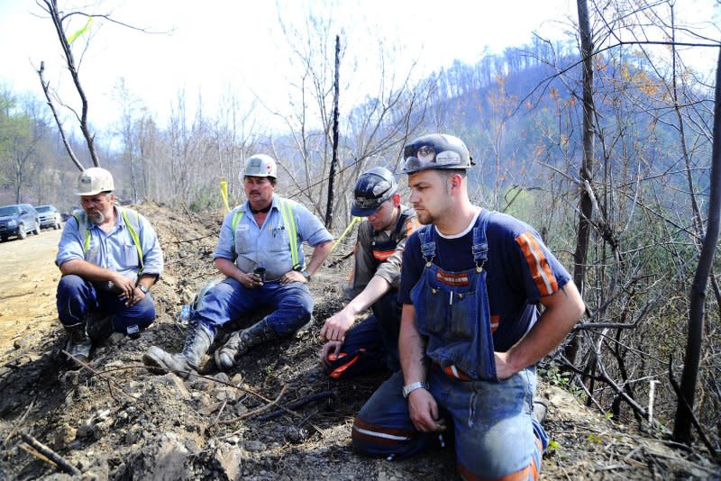Massey Energy workers Maurice Blanchette (L), Jimmy Shortridge (2nd-L), Brandon Waddell (2nd-R) and Andrew Lucas take a break from drilling efforts above Massey Energy's Upper Big Branch Coal Mine on April 7, 2010, in Montcoal, W.Va. On April 5, 2010, an explosion in a coal mine near Montcoal, in West Virginia's Raleigh County, killed 29 workers. File Photo by Jeff Gentner/UPI