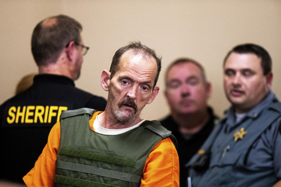 Kirby Gene Wallace enters the courtroom during his first appearance at the Stewart County Courthouse Tuesday, Oct. 9, 2018, in Dover, Tenn. Wallace, a multiple-murder suspect who led Tennessee law enforcement on an intense 7-day manhunt was captured without a struggle Friday morning, Oct. 5, in a wooded area about two hours northwest of Nashville. Wallace was wanted in two counties on charges that include murder, arson and kidnapping. (Courtney Pedroza/The Tennessean via AP, Pool)