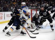 January 21, 2019; Los Angeles, CA, USA; St. Louis Blues center Ryan O'Reilly (90) moves the puck as Los Angeles Kings center Jeff Carter (77) helps goaltender Jonathan Quick (32) defend the goal during the third period at Staples Center. Mandatory Credit: Gary A. Vasquez-USA TODAY Sports