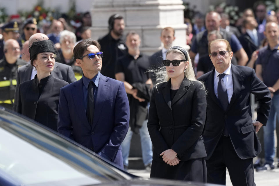 Paolo Berlusconi, brother of former Italian premier Silvio Berlusconi, right, and Silvio Berlusconi's children Barbara, second from right, Pier Silvio, and Eleonora, left, wait for their father's hearse to arrive for a state funeral, at Milan's Duomo Gothic Cathedral, Italy, Wednesday, June 14, 2023. Berlusconi died at the age of 86 on Monday in a Milan hospital where he was being treated for chronic leukemia. (AP Photo/Antonio Calanni)