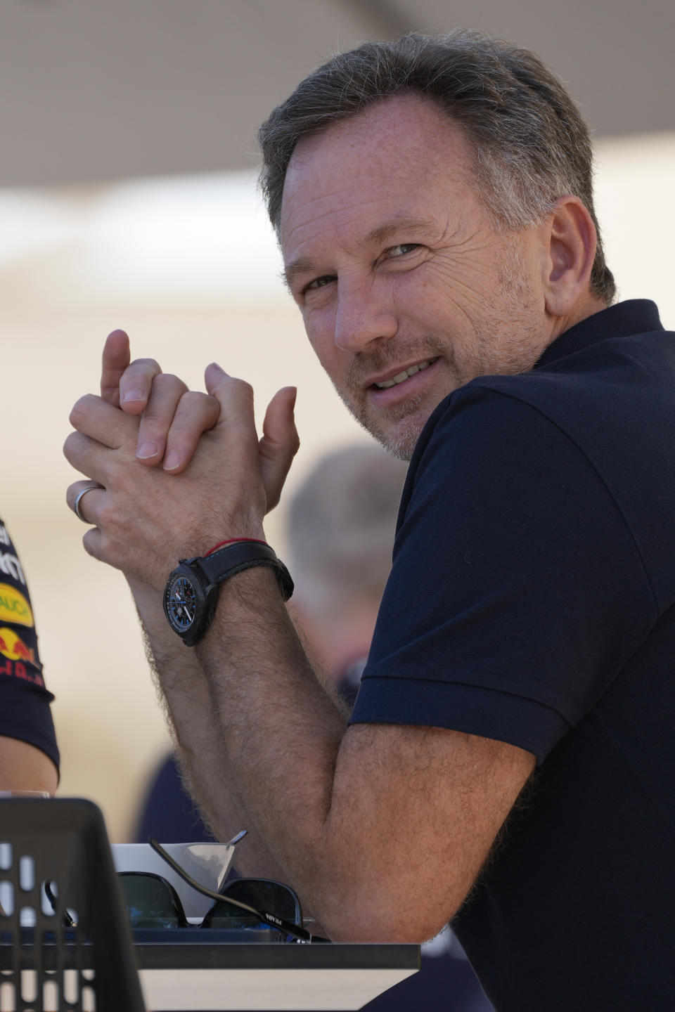 Red Bull team principal Christian Horner sits in the paddock during Formula One pre season testings at the Bahrain International Circuit in Sakhir, Bahrain, Wednesday, Feb. 21, 2024. (AP Photo/Darko Bandic)