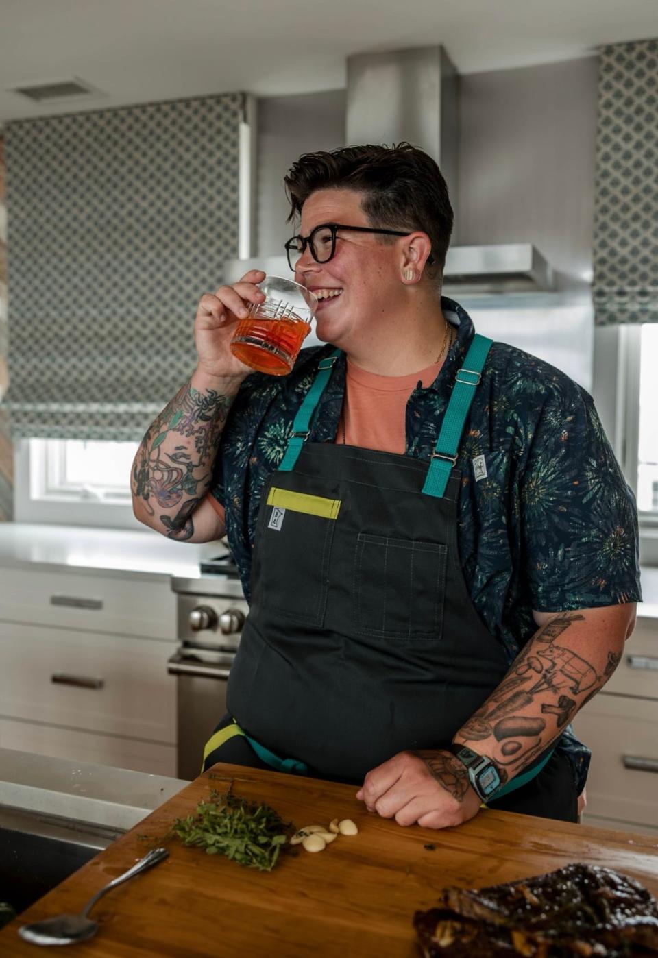 Chef Britt Rescigno of New Gretna enjoys a drink while cooking.