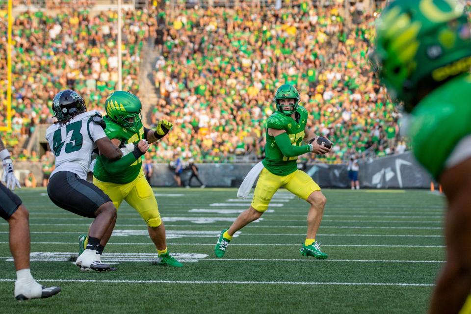 Oregon quarterback Bo Nix scrambles with the ball as the Oregon Ducks host Hawaii Saturday, Sept. 16, 2023, at Hayward Field in Eugene, Ore.