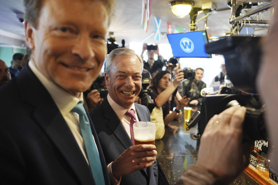 Leader of Reform UK Nigel Farage holds a pint of beer as he launches his General Election campaign at a pub in Clacton-on-Sea, Essex, England, Tuesday June 4, 2024. Mr Farage announced on Monday that he will stand for parliament in Clacton and lead Reform UK for the next five years. (James Manning/PA via AP)