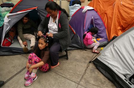 Residents of the town Cerro de Pasco in the Peruvian Andes stand outside the health ministry during a protest for what they describe as rampant pollution from a sprawling polymetallic mine operated by Peruvian mining company Volcan, in Lima, Peru June 22, 2017. REUTERS/Mariana Bazo