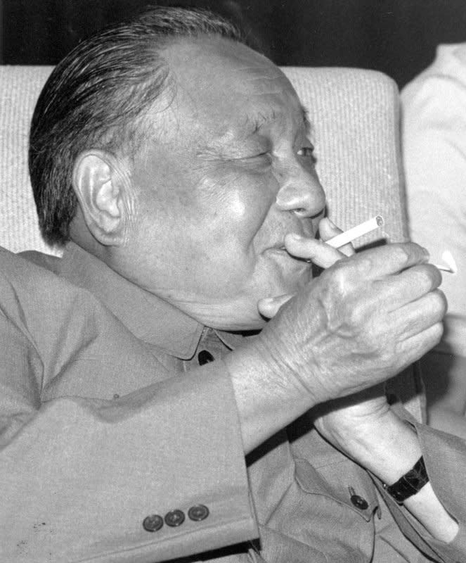 Chinese leader Deng Xiaoping lights up a cigarette in 1985. Deng died February 19, 1997. UPI File Photo