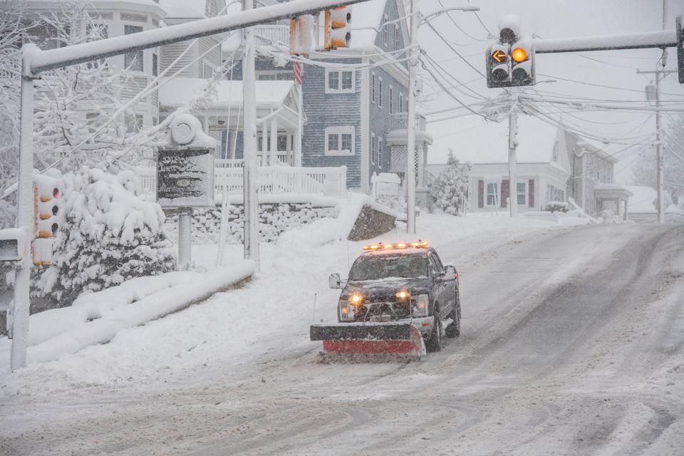 A snowplow clears snow from Broadway in Methuen, Massachusetts on January 7 (AFP via Getty Images)