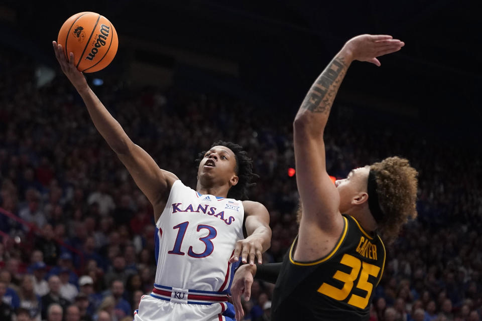 Kansas guard Elmarko Jackson (13) shoots over Missouri forward Noah Carter (35) during the first half of an NCAA college basketball game Saturday, Dec. 9, 2023, in Lawrence, Kan. (AP Photo/Charlie Riedel)