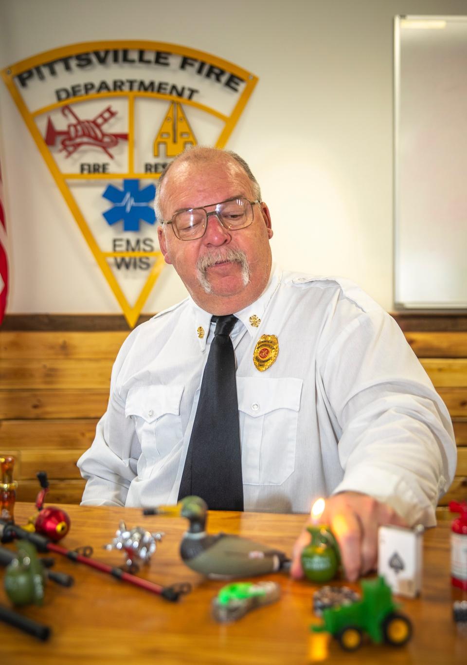 Pittsville Fire Chief Jerry Minor shows the functionality and tricks of his collection of novelty lighters at Pittsville Fire Department in Pittsville, Wisconsin on Tuesday, March 26, 2024. Chief Minor likes to take the lighters to fire safety lessons and show them side by side with his grandson’s old toys, demonstrating the near unidentifiable differences and the danger that implies.