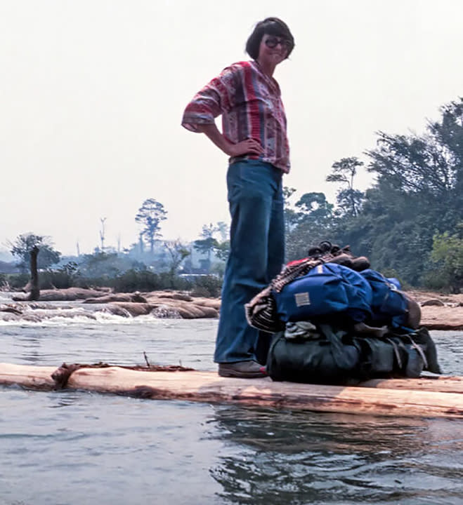 old pic of a woman on a log raft