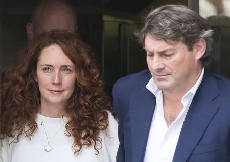 Former News International chief executive Rebekah Brooks and her husband Charlie leave the Old Bailey courthouse in London June 24, 2014. REUTERS/Neil Hall