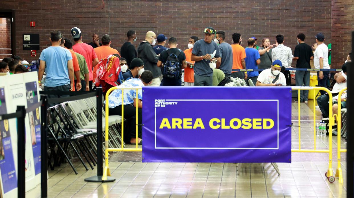 Newly arrived migrants are pictured in a closed holding area at the Port Authority Bus Terminal in Midtown Manhattan, New York on Sept. 19, 2022.