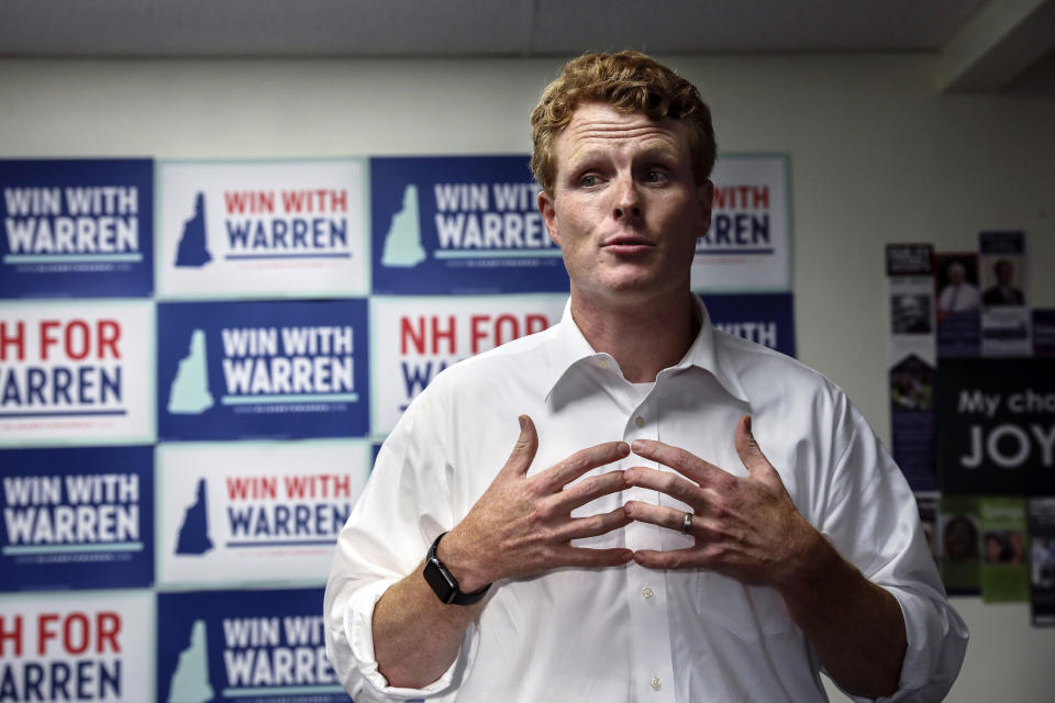 FILE - In this Sept. 5, 2019 file photo, Rep. Joseph Kennedy III, D-Mass., talks to volunteers while campaigning for Democratic presidential candidate Sen. Elizabeth Warren at the New Hampshire for Warren kick off field office opening in Manchester, N.H. Kennedy plans to announce on Saturday, Sept. 21, that he will challenge U.S. Sen. Edward Markey, D-Mass., in the 2020 Democratic primary. (AP Photo/Cheryl Senter, File)