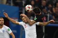 <p>Croatia’s forward Mario Mandzukic (R) heads the ball with England’s defender John Stones the Russia 2018 World Cup semi-final football match between Croatia and England at the Luzhniki Stadium in Moscow on July 11, 2018. (Photo by Kirill KUDRYAVTSEV / AFP) </p>