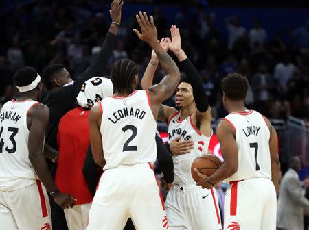 Nov 20, 2018; Orlando, FL, USA; Toronto Raptors guard Danny Green (14) celebrates with forward Kawhi Leonard (2) and guard Kyle Lowry (7) and forward Pascal Siakam (43) and teammates after shooting the game winning basket during the fourth quarter to beat the Orlando Magic at Amway Center. Mandatory Credit: Kim Klement-USA TODAY Sports