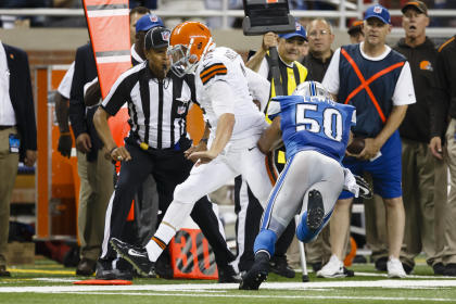 Johnny Manziel is forced out of bounds by Lions LB Travis Lewis. (AP)