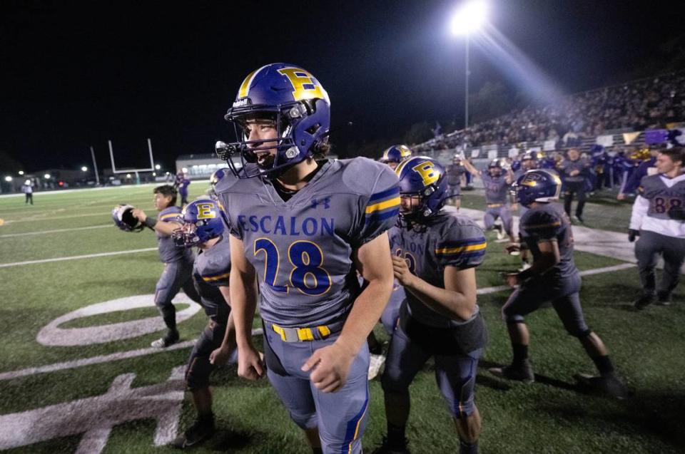 Cruz Snow and his Escalon teammates jump for joy after winning the Sac-Joaquin Section Division IV championship game over Patterson at St. Mary’s High School in Stockton, Calif., Friday, Nov. 24, 2023.