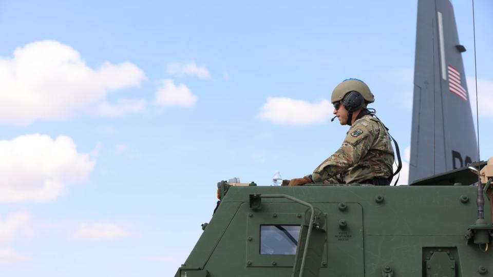 A soldier assigned to 3rd Battalion, 27th Field Artillery Regiment, 18th Field Artillery Brigade, sits in the main control position of a High Mobility Artillery Rocket System vehicle in preparation for a HIMARS Rapid Simulation, during Arcane Thunder 23 at Mihail Kogălniceanu Air Base, Romania, Sept. 4, 2023. (Staff Sgt. Erick Yates/Army)