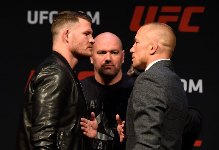 Middleweight champion Michael Bisping (L) squared off with Georges St-Pierre at a March 3 news conference, but the two won’t be fighting any time soon. (Getty Images)