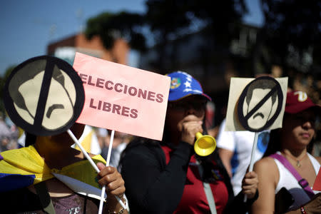 Opposition supporters take part in a rally against Venezuelan President Nicolas Maduro's government in Caracas, Venezuela February 2, 2019. A placard reads: "Free elections". REUTERS/Andres Martinez Casares