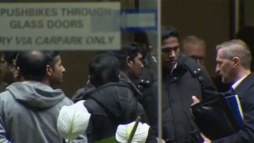 Police are seen briefing members of the family. Photo: 7 News