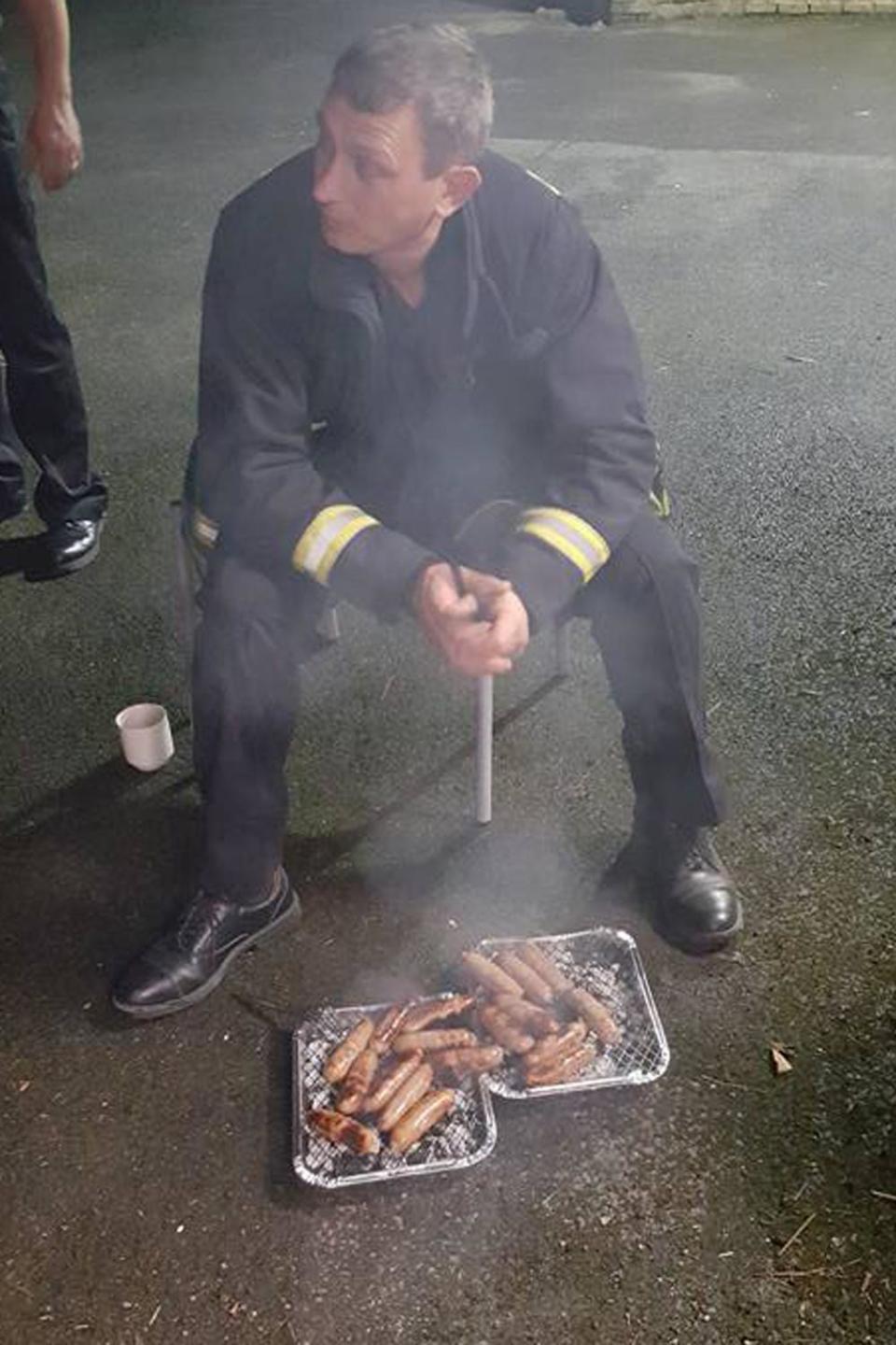 Tasty treat: A fire fighter BBQs sausages after saving a litter of piglets in February (Pewsey Fire Station/Facebook)