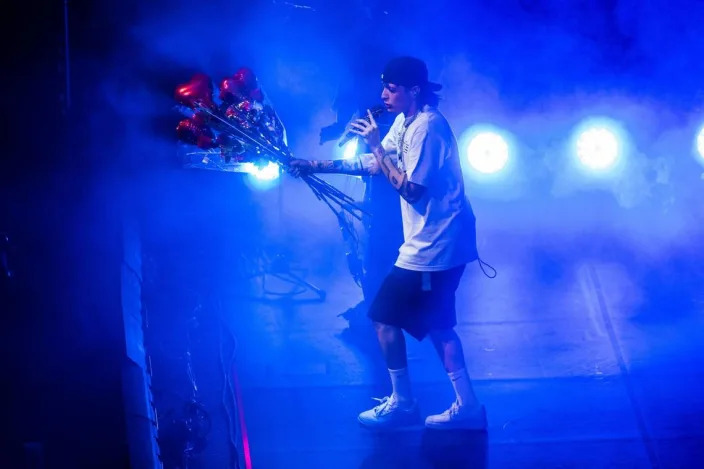 Mexican singer Peso Pluma holds a bouquet of balloons on Sunday, July 9, 2023, as he performs at Golden 1 Center as part of his 31-city Doble P Tour. Peso Pluma became the first Mexican artist to hit No. 1 on the Spotify Global Top Songs chart. This year, eight of his songs have landed on the Billboard Hot 100 chart.