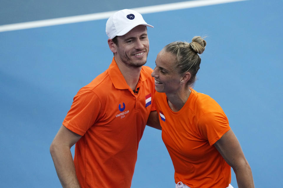 Arantxa Rus of Netherlands celebrated with team captain Wesley Koolhof, left, after her win over Malene Helgo of Norway during the United Cup tennis tournament in Sydney, Saturday, Dec. 30, 2023. (AP Photo/Rick Rycroft)